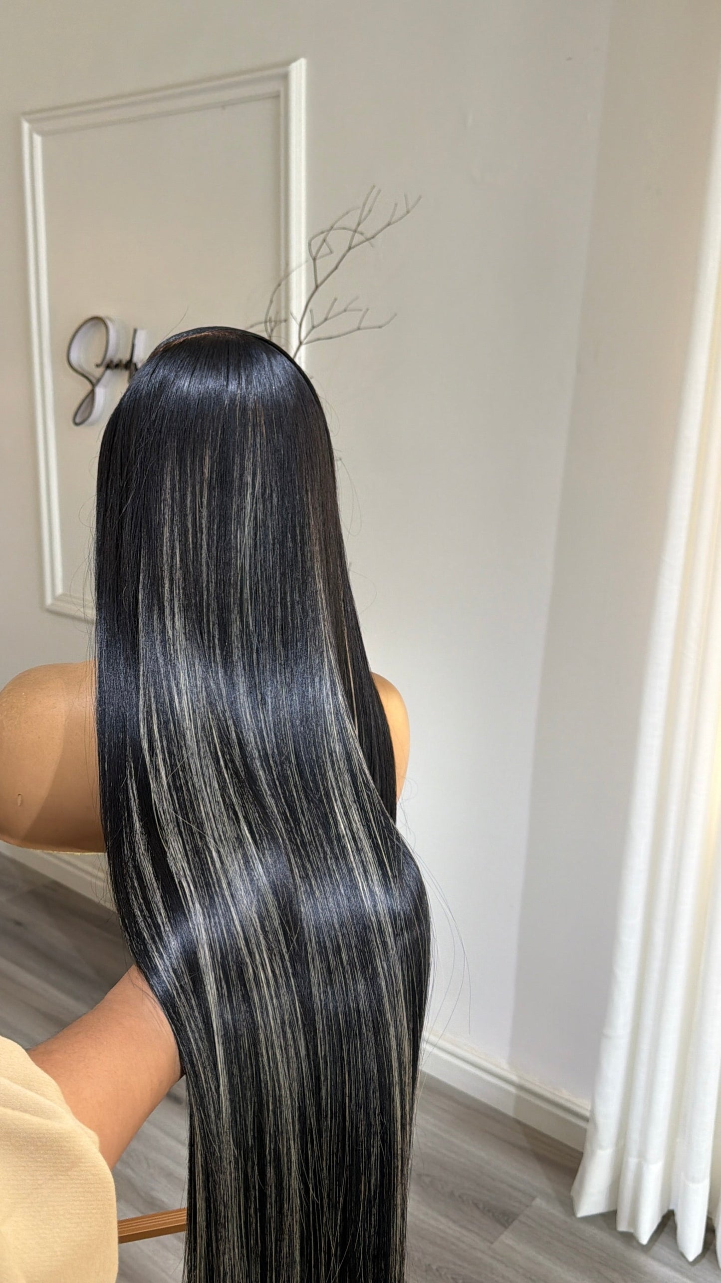 Back view of the Buss Down Midnight Black 30-inch raw human hair wig showcasing its sleek straight finish, dimensional highlights and HD lace construction.