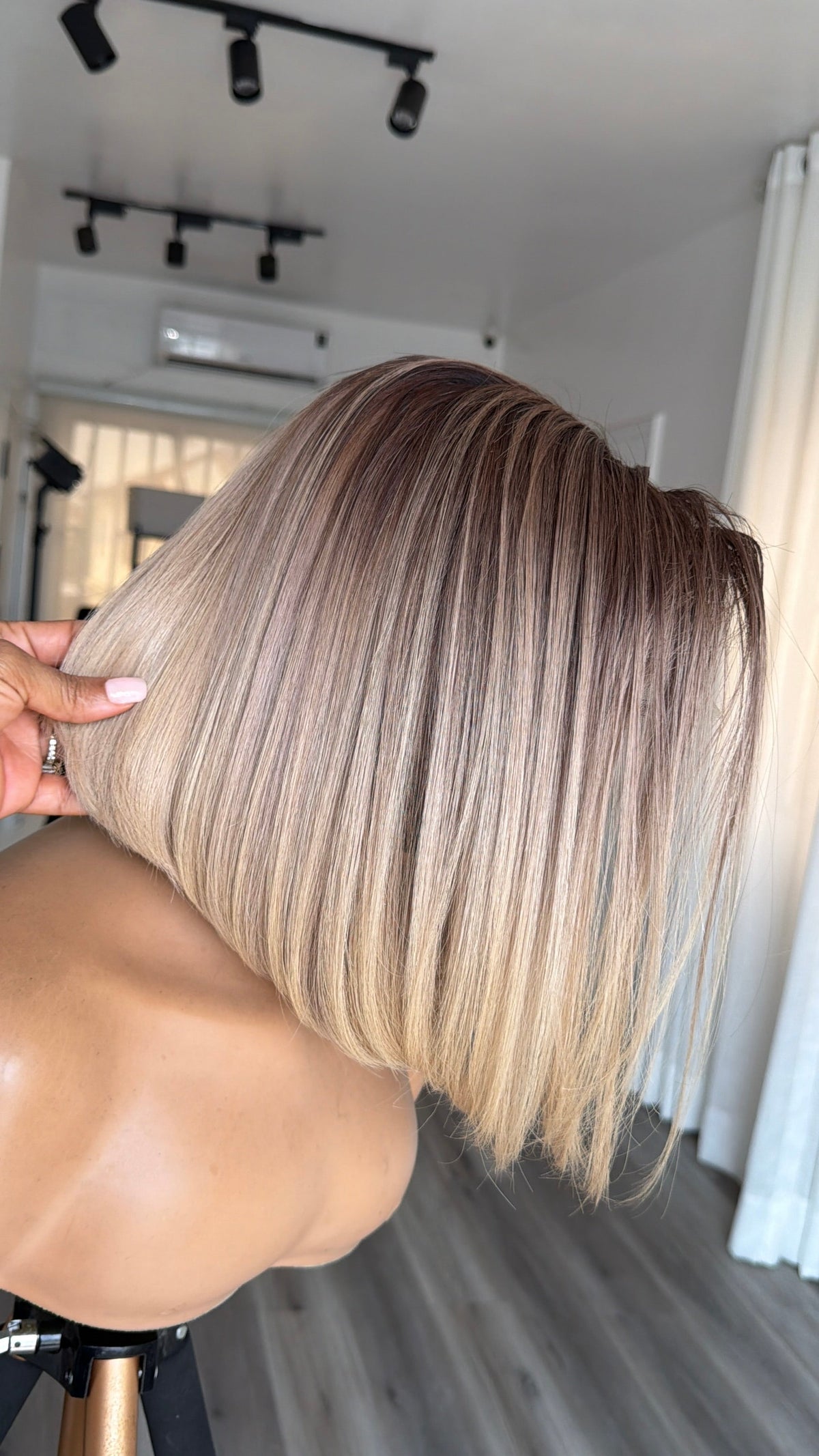 Latte Blonde Bob human hair wig with an HD lace closure, 10–12 inch length and a sleek natural finish.