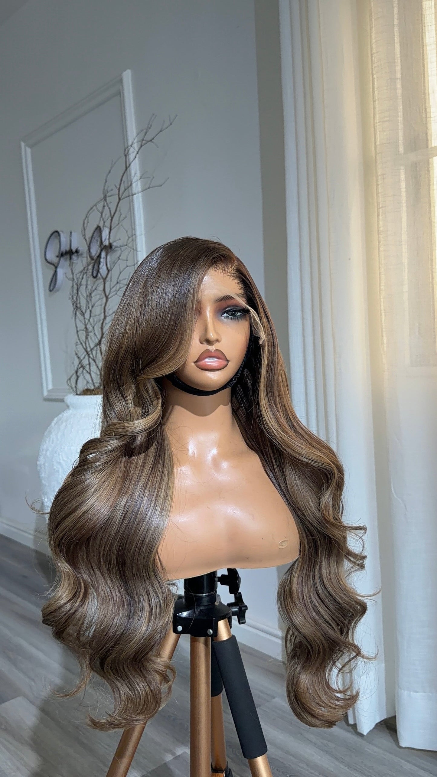 Back view of the Mocha Brunette Wavy 24-inch raw human hair wig showcasing its rich brunette colour, soft waves and premium 9x6 HD lace closure.