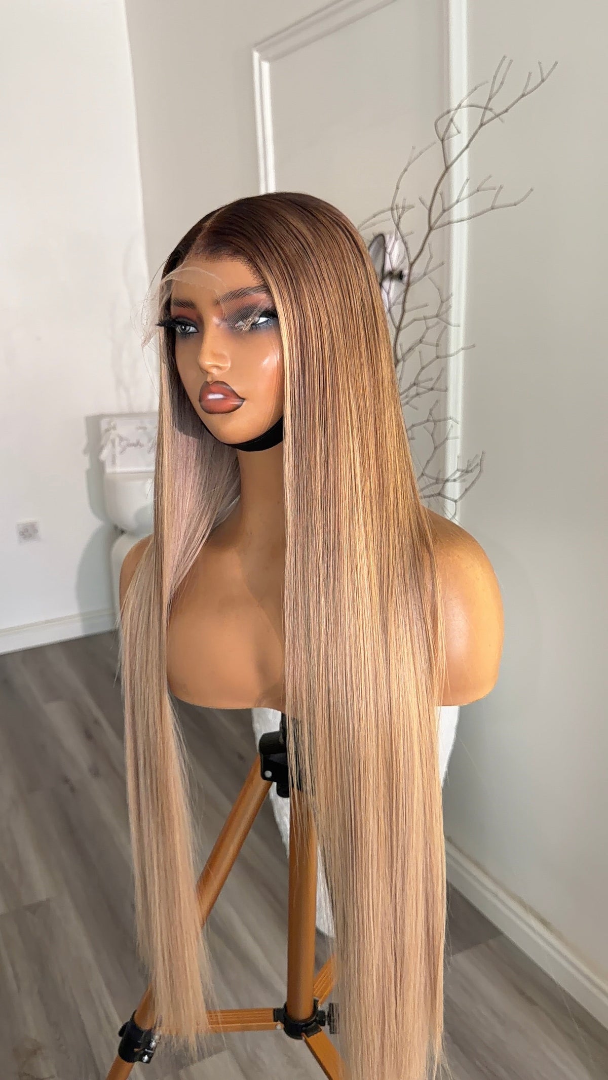 Side view of the Vanilla Beige Blonde 26-inch straight raw human hair wig featuring a seamless 6x6 HD lace closure.